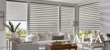 Modern living room with striped window blinds and neutral-toned furniture.