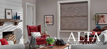 Cozy living room with wood fireplace and stylish window blinds.