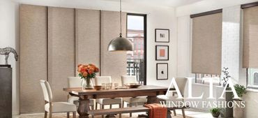 Modern dining room with beige window treatments and a wooden table.