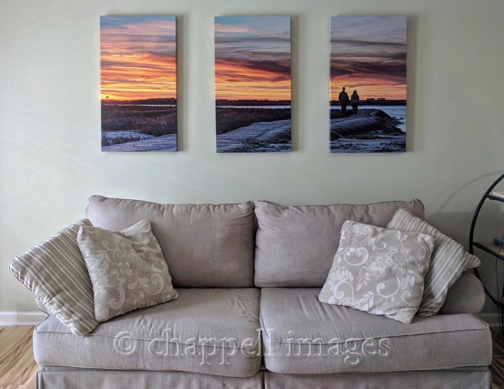 living room, couch with triptych of couple walking into the sunset hanging above couch.