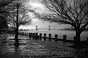 Fog blankets the Cape Fear River in downtown Wilmington, NC Cape fear Bridge in distance