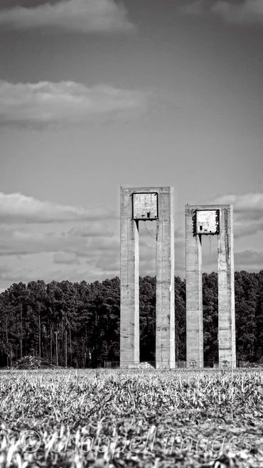 Concrete structures tower above the trees in a WWII blimp Moring Field Weeksville, NC