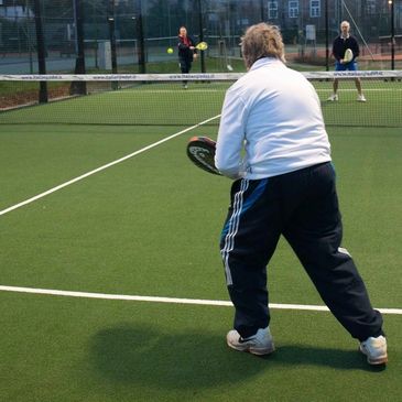A padel doubles match in progress at Epsom Sports Club