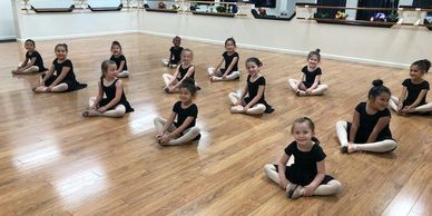 ballet dancers sitting and stretching