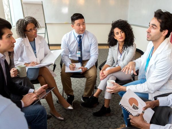 Healthcare team in discussion during a meeting, symbolizing professional education