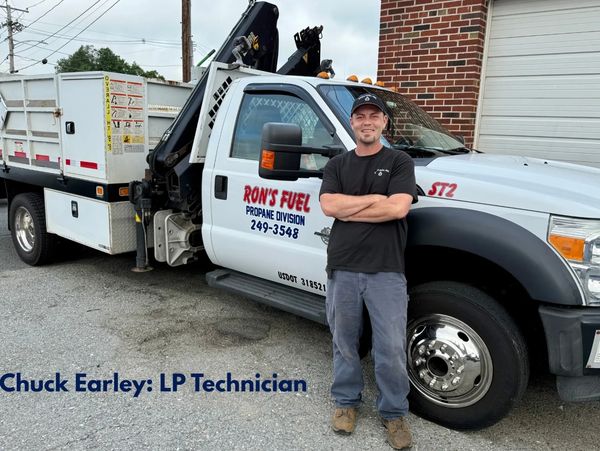 LP technician Chuck Earley stands beside a Ron's Fuel propane truck.
