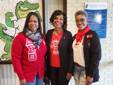 Three women smiling indoors at Eastern Gateway Community College.