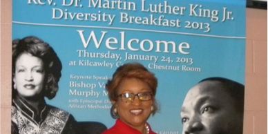Woman in red coat at MLK Jr. Diversity Breakfast 2013.