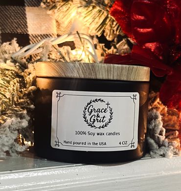 Grace & Grit soy wax candle with festive decorations and warm lighting.