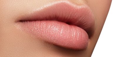 a close up of some attractive lips with peach coloured gloss