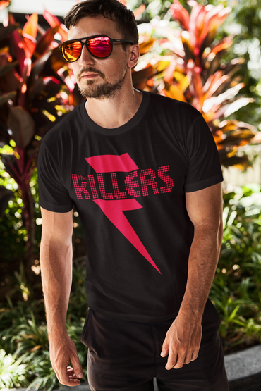 Man wearing a black The Killers band T-shirt and reflective sunglasses outdoors.