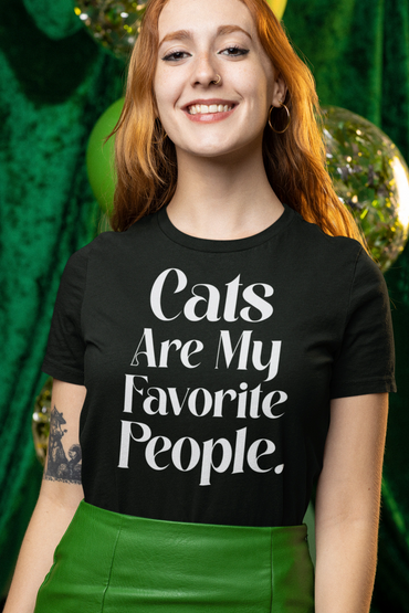 Smiling woman wearing a black t-shirt that says "Cats Are My Favorite People."
