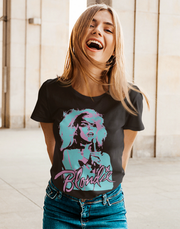 Young woman laughing, wearing a Blondie graphic tee and blue jeans.