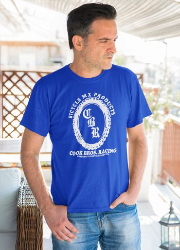 Man wearing a blue T-shirt with a bicycle-themed logo and text.