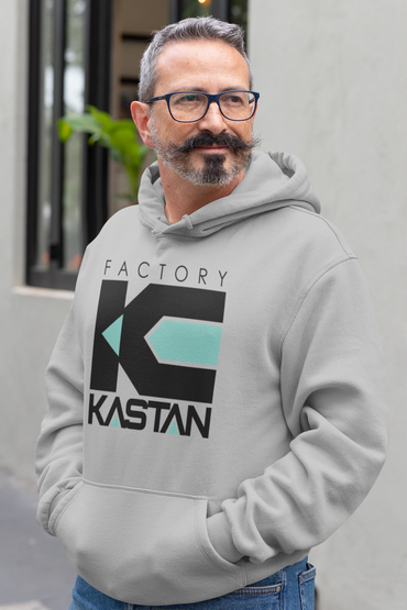 Man wearing a gray hoodie with a black and turquoise "Factory Kastan" logo.