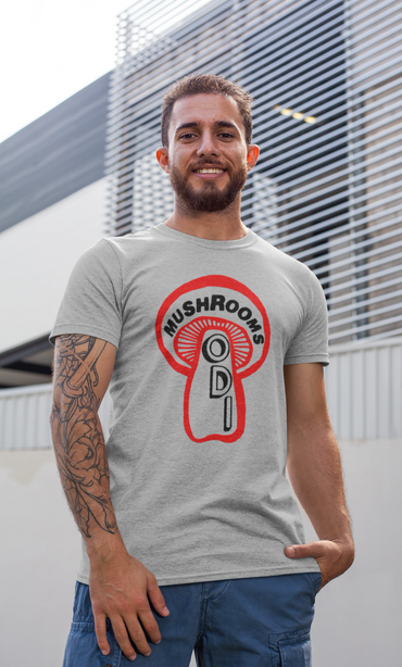 Smiling man wearing a gray t-shirt with a red mushroom design and text.