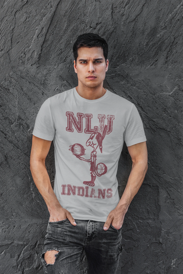 Man wearing a white NLJ Indians t-shirt with black ripped jeans against a textured wall.
