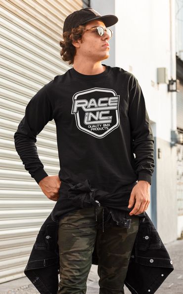 Young man wearing a black Race Inc. shirt and camo pants.