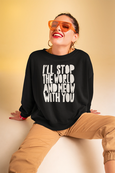 Smiling woman in orange sunglasses and black sweatshirt with playful text.