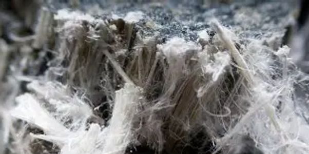 Close-up of fibrous asbestos material with a grayish tone.