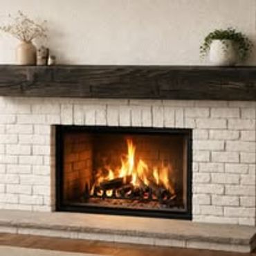 Cozy fireplace with burning wood and a rustic wooden mantel.