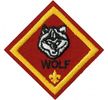 Wolf patch.  The patch is red with the head of a wolf above W-O-L-F and a Fleur de Lis.