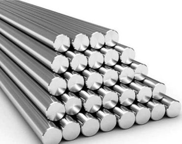 Stack of shiny metal rods arranged in a pyramid shape.