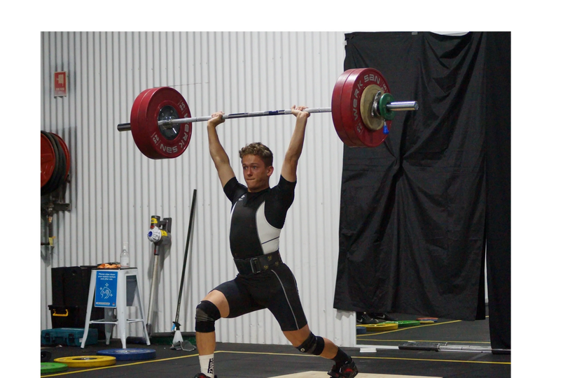 Youth athlete competing at an olympic weightlifting competition coached by Empower weightlifting