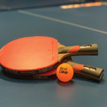 Ping Pong on our premium Stiga tables, spectators watching in background