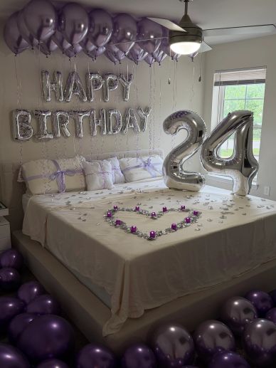 Birthday decorations with silver balloons and purple accents.