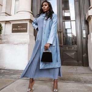 London-based influencer Mosope in silver blue gray ensemble, pointed stilettoes, sleek black purse