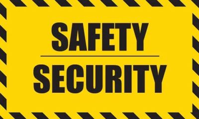Yellow and black sign reading Safety Security emphasizing caution.