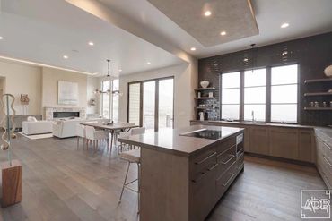 modern white kitchen with brown tile backsplash