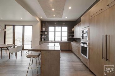 modern white kitchen with brown tile backsplash