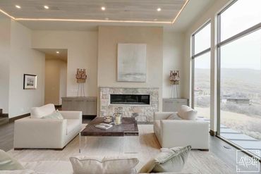 modern white living room with stone fireplace
