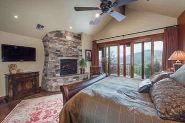 modern master bedroom with rock fireplace
