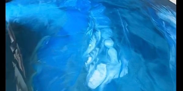 Room with a glossy, blue, marble-like epoxy floor.