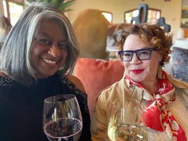 Greer and friend toast to a longtime friendship in the tasting room.