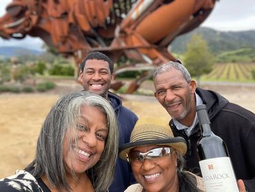 Greer and family pose next to the giant bore metal sculpture at Soda Rock in Alexander Valley.