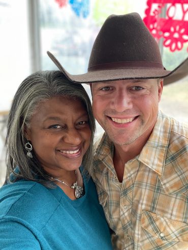 Greer and cowboy share a moment of fun at a barbecue cookoff.