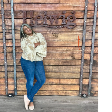 Greer leans agains the rustic wood wall at Helwig.