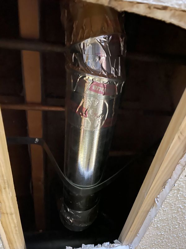 Metal duct pipe in ceiling insulation.