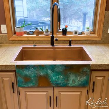 Drop in copper farmhouse kitchen sink with a NexGen workstation and blue wave patina