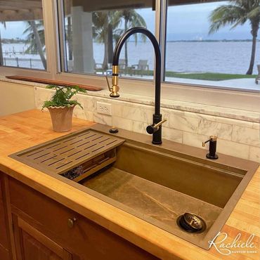 35" custom bronze top mount workstation sink by Rachiele that replaced a small double bowl sink