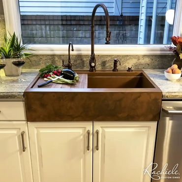 Beautiful custom copper farmhouse sink with wood cutting board and Waterstone faucet by Rachiele