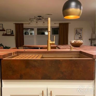 36" copper farmhouse sink with a custom patina and signature series workstation in wood countertops