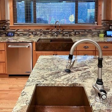 Kitchen with two copper sinks, one copper farmhouse sink and one undermount prep sink earth tones