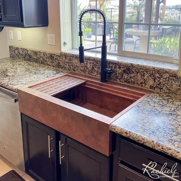36" custom copper farmhouse sink with a two tier workstation that replaced a double bowl sink.
