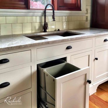 Full size double rollout trash under a 36 inch Rachiele custom undermount sink.