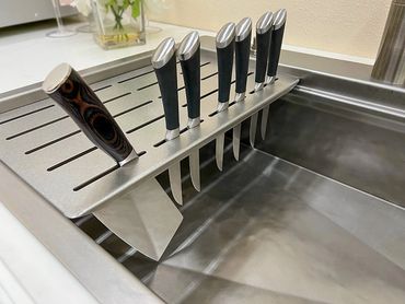 A custom sink accessory that doubles as a drying rack and knife holder by Rachiele Custom Sinks